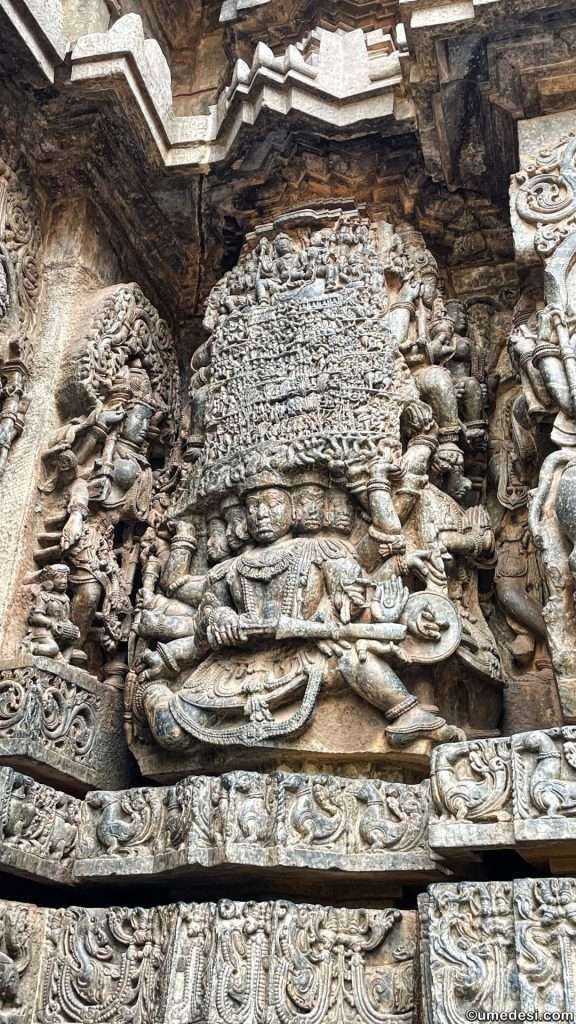 Sculpture of Ravana lifting Mount Kailash carved on the walls of Hoysaleswara Temple.