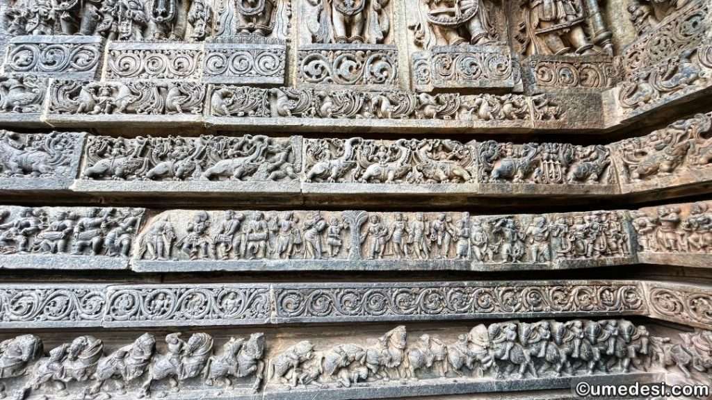 Close-up of the decorative friezes on the exterior walls of Hoysaleswara Temple, showcasing elephants and floral motifs.