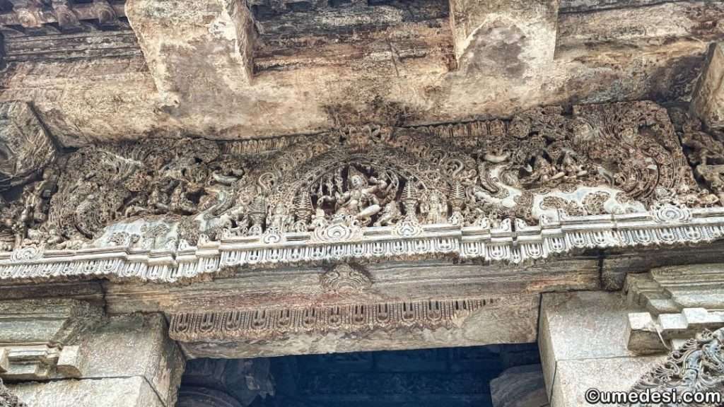 "Exquisitely detailed lintel carving at Hoysaleswara Temple showcasing mythological figures and decorative motifs.