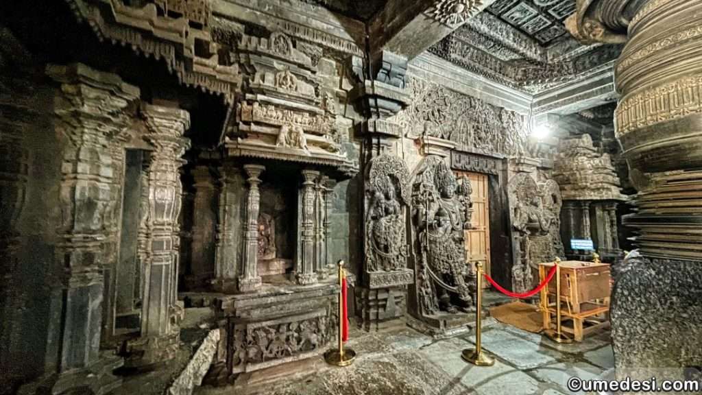 Inner sanctum of Hoyasaleswara Temple featuring intricate carvings, deity sculptures, and detailed pillars.