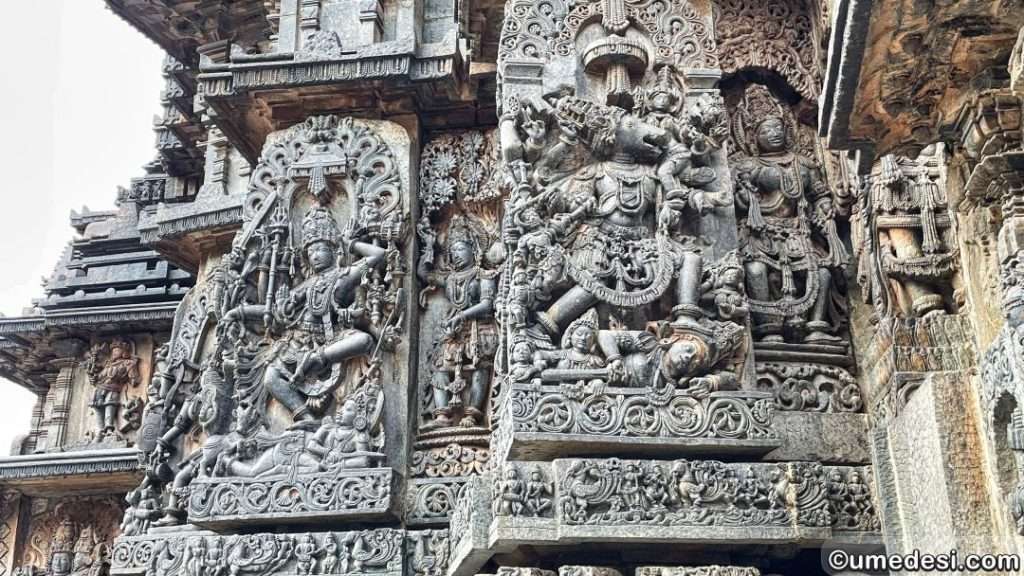Elaborate exterior sculptures on the walls of Hoysaleswara Temple depicting scenes from the Puranas.
