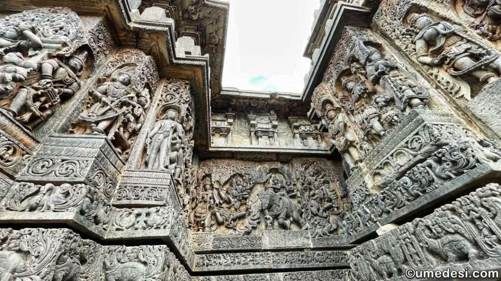 Corner of Hoysaleswara Temple adorned with intricate sculptures of deities and mythological scenes.
