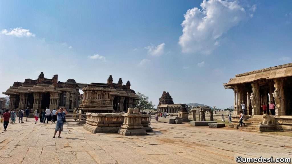 Temple courtyard of Vijaya Vittala Temple featuring stone pillared halls and ancient architecture.
