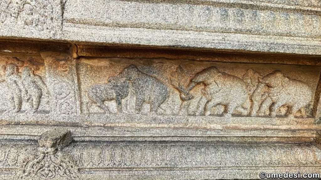 Stone carvings of elephants and floral designs on the temple walls in Vijaya Vittala Temple, Hampi.