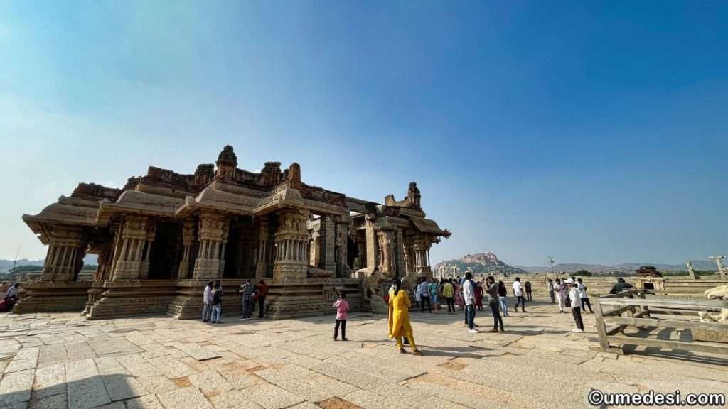 Wide-angle view of Vijaya Vittala Temple with visitors exploring the site, Hampi.
